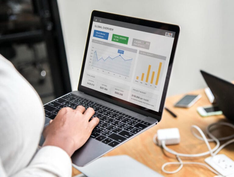 Person working on laptop at desk in workspace