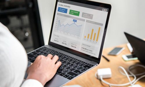 Person working on laptop at desk in workspace